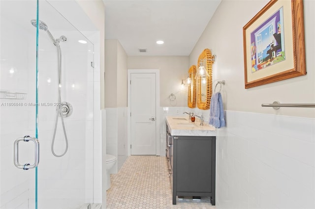 14270 SW 74th Ct, Palmetto Bay, FL 33158 - bathroom with a stall shower, vanity, tile walls, toilet, and wainscoting