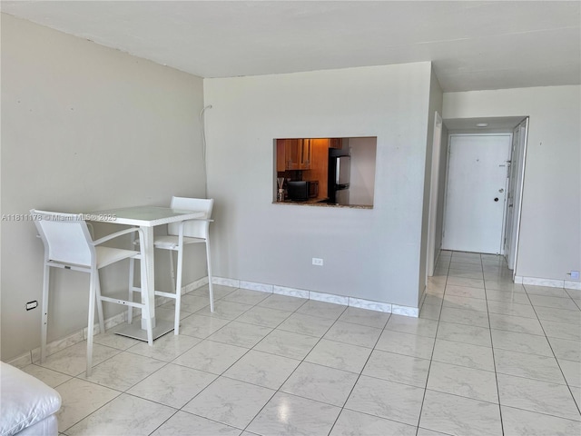 5555 Collins Ave Unit 6E, Miami Beach, FL 33140 - dining space with baseboards and light tile patterned flooring