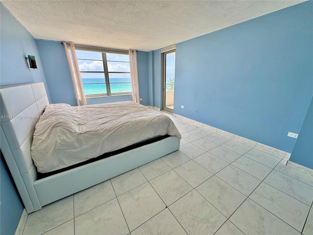 5555 Collins Ave Unit 6E, Miami Beach, FL 33140 - bedroom with a textured ceiling and baseboards