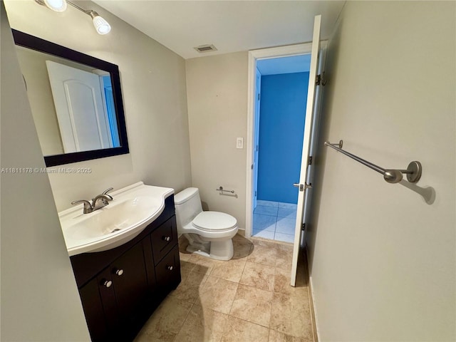 5555 Collins Ave Unit 6E, Miami Beach, FL 33140 - bathroom with toilet, vanity, and tile patterned floors