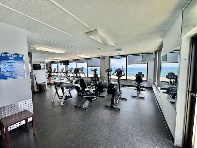 5555 Collins Ave Unit 6E, Miami Beach, FL 33140 - workout area with plenty of natural light and a textured ceiling