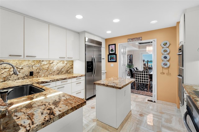 2213 Fisher Island Dr Unit 3103, Miami Beach, FL 33109 - kitchen featuring stainless steel appliances, a sink, tasteful backsplash, light stone counters, and recessed lighting