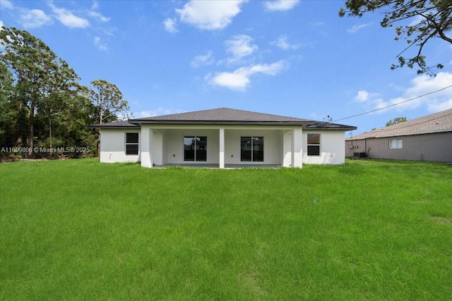 4800 Nelson Dr, Lehigh Acres, FL 33973 - back of property with a yard and stucco siding