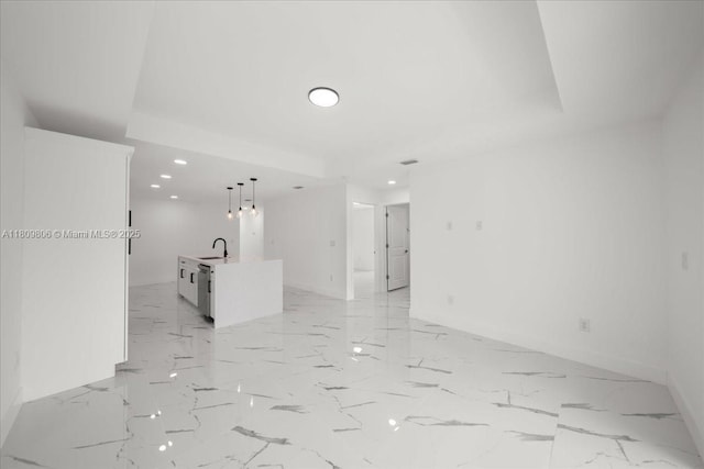 4800 Nelson Dr, Lehigh Acres, FL 33973 - spare room featuring a sink, recessed lighting, baseboards, light marble finish flooring, and a raised ceiling
