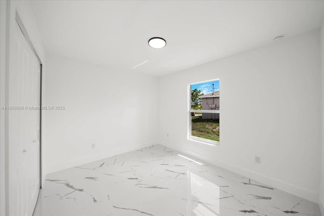 4800 Nelson Dr, Lehigh Acres, FL 33973 - empty room featuring light marble finish floors and baseboards