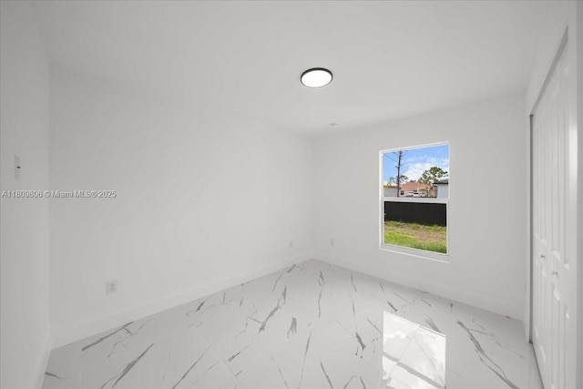 4800 Nelson Dr, Lehigh Acres, FL 33973 - empty room featuring baseboards and light marble finish floors