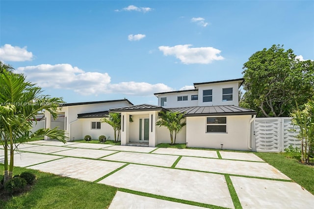 2001 SW 23rd Ave, Fort Lauderdale, FL 33312 - rear view of property featuring a standing seam roof, stucco siding, and metal roof