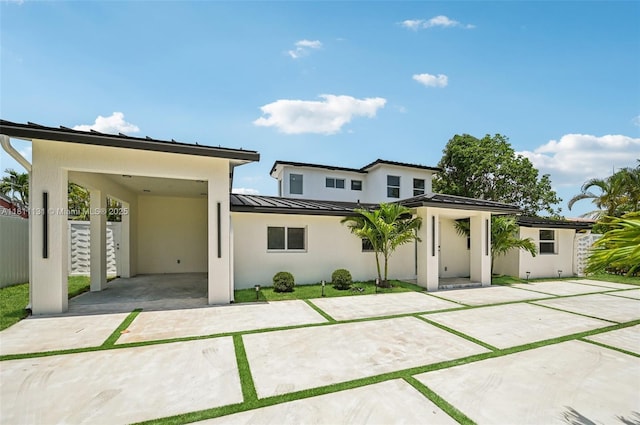 2001 SW 23rd Ave, Fort Lauderdale, FL 33312 - view of front of house featuring a standing seam roof, stucco siding, metal roof, and a carport