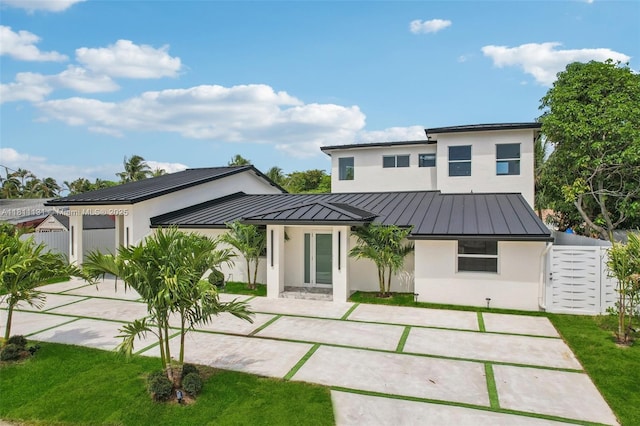2001 SW 23rd Ave, Fort Lauderdale, FL 33312 - back of house featuring a standing seam roof, stucco siding, metal roof, and concrete driveway