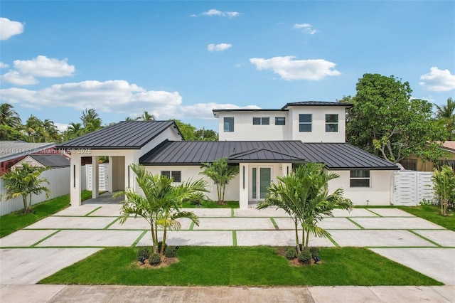 2001 SW 23rd Ave, Fort Lauderdale, FL 33312 - back of property with a standing seam roof, stucco siding, concrete driveway, metal roof, and a carport