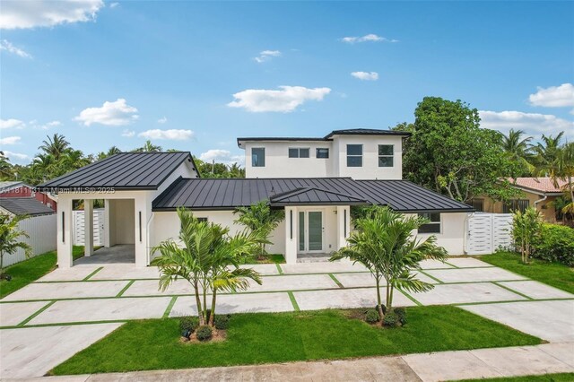 2001 SW 23rd Ave, Fort Lauderdale, FL 33312 - view of front of house with a standing seam roof, stucco siding, driveway, metal roof, and a carport