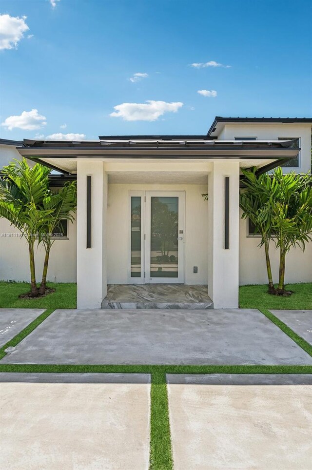 2001 SW 23rd Ave, Fort Lauderdale, FL 33312 - doorway to property with a patio area and stucco siding