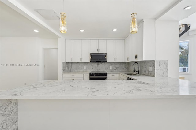 2001 SW 23rd Ave, Fort Lauderdale, FL 33312 - kitchen with stainless steel microwave, range with electric stovetop, a sink, backsplash, and recessed lighting