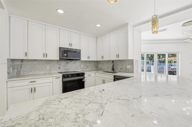 2001 SW 23rd Ave, Fort Lauderdale, FL 33312 - kitchen with range with electric stovetop, stainless steel microwave, light stone countertops, recessed lighting, and a sink