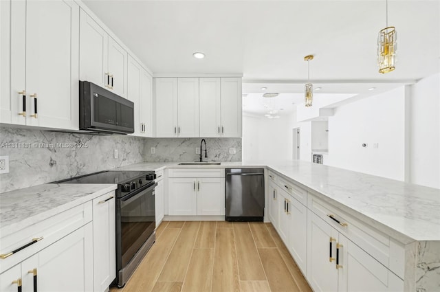 2001 SW 23rd Ave, Fort Lauderdale, FL 33312 - kitchen featuring black appliances, a sink, light wood-style flooring, white cabinetry, and light stone countertops