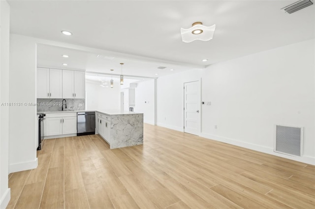 2001 SW 23rd Ave, Fort Lauderdale, FL 33312 - kitchen with dishwasher, a peninsula, open floor plan, light countertops, and white cabinets