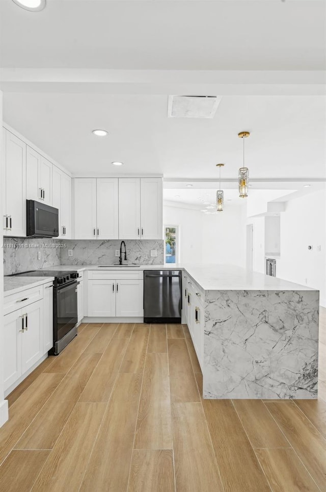 2001 SW 23rd Ave, Fort Lauderdale, FL 33312 - kitchen with black appliances, a peninsula, light wood-style flooring, a sink, and recessed lighting