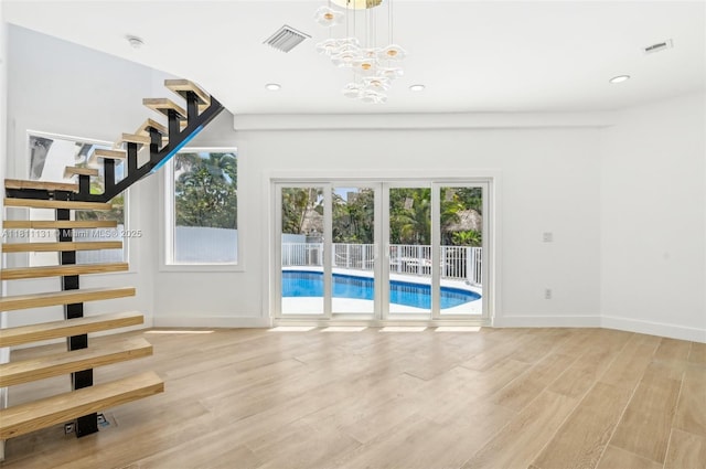 2001 SW 23rd Ave, Fort Lauderdale, FL 33312 - unfurnished living room with stairway, light wood-style flooring, a chandelier, recessed lighting, and baseboards