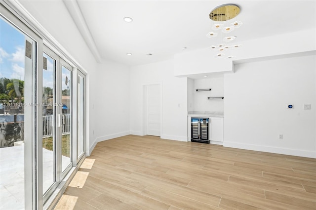 2001 SW 23rd Ave, Fort Lauderdale, FL 33312 - unfurnished living room featuring wine cooler, plenty of natural light, light wood-style flooring, baseboards, and recessed lighting