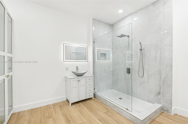 2001 SW 23rd Ave, Fort Lauderdale, FL 33312 - bathroom with a marble finish shower, vanity, wood finished floors, baseboards, and recessed lighting