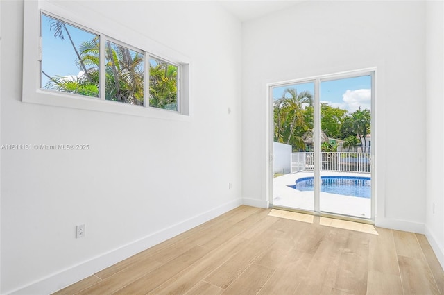 2001 SW 23rd Ave, Fort Lauderdale, FL 33312 - empty room featuring healthy amount of natural light, wood finished floors, and baseboards