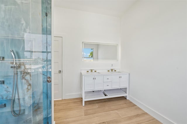 2001 SW 23rd Ave, Fort Lauderdale, FL 33312 - bathroom featuring double vanity, a marble finish shower, baseboards, and wood tiled floors