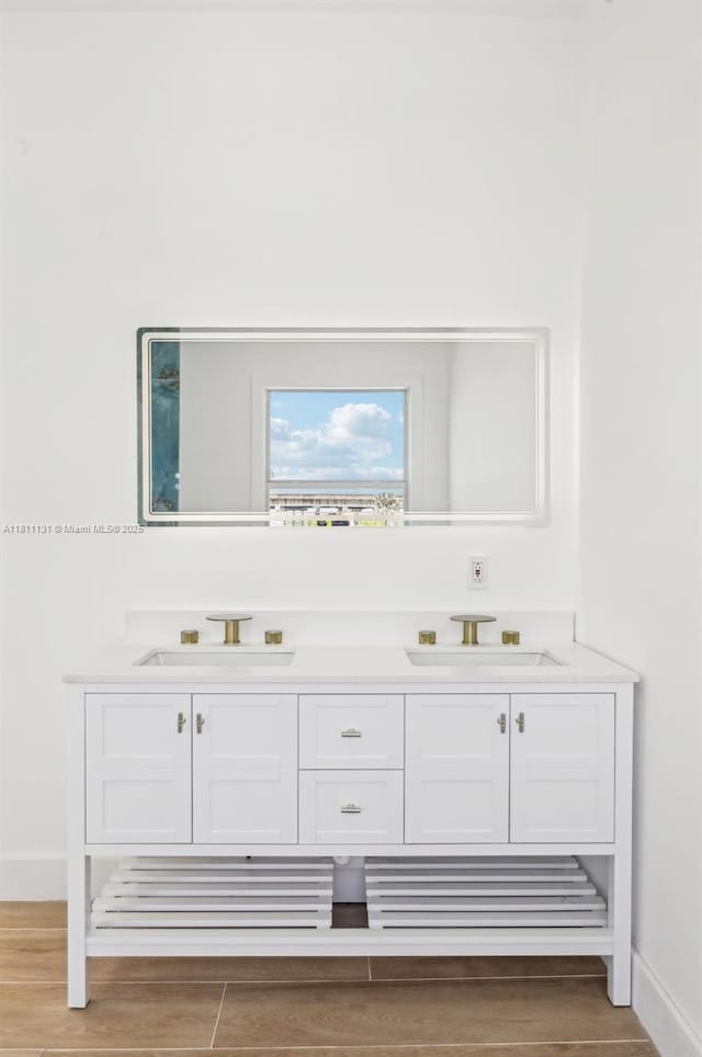 2001 SW 23rd Ave, Fort Lauderdale, FL 33312 - bathroom view of double vanity, baseboards, and wood finished floors