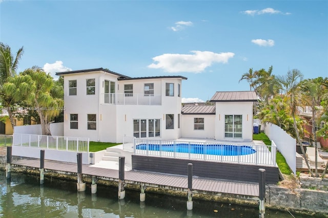 2001 SW 23rd Ave, Fort Lauderdale, FL 33312 - back of property featuring a balcony, stucco siding, a water view, and an outdoor pool