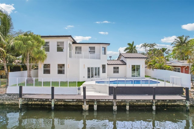 2001 SW 23rd Ave, Fort Lauderdale, FL 33312 - rear view of house with a balcony, stucco siding, a standing seam roof, and a water view