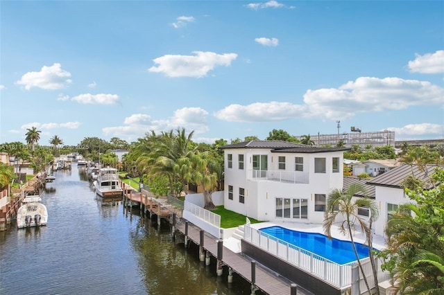 2001 SW 23rd Ave, Fort Lauderdale, FL 33312 - back of property with a balcony, stucco siding, an outdoor pool, metal roof, and a water view