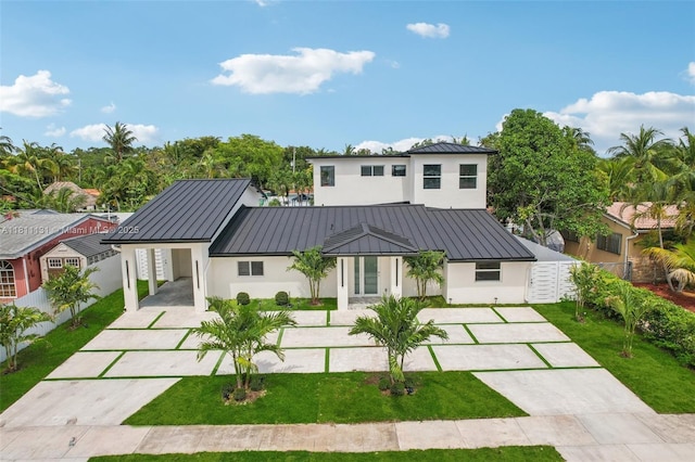 2001 SW 23rd Ave, Fort Lauderdale, FL 33312 - rear view of property featuring concrete driveway, stucco siding, a standing seam roof, metal roof, and an attached carport