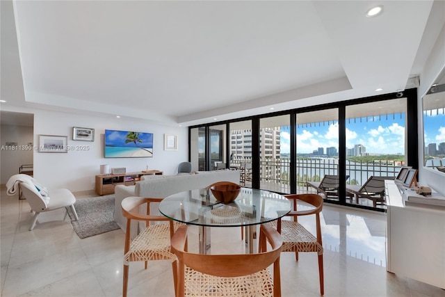 2 Grove Isle Dr Unit B1108, Miami, FL 33133 - dining room featuring a tray ceiling, plenty of natural light, recessed lighting, and a wall of windows
