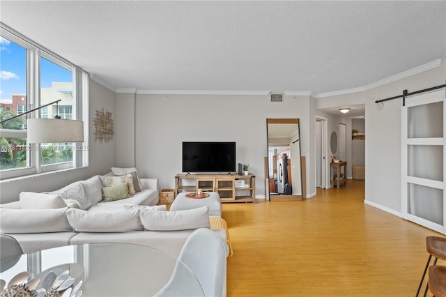 2000 N Bayshore Dr Unit 401, Miami, FL 33137 - living area with light wood-style flooring, crown molding, a barn door, a textured ceiling, and baseboards