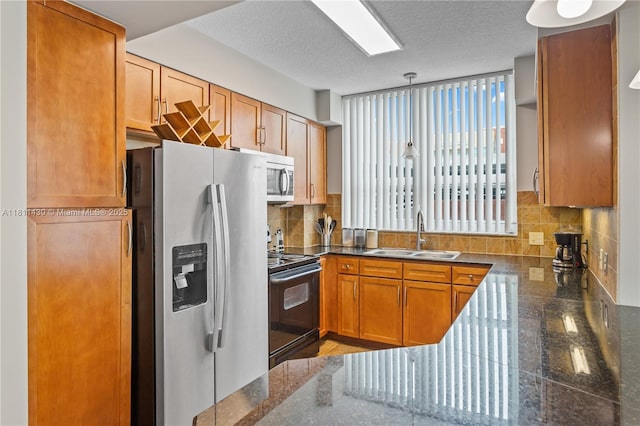 2000 N Bayshore Dr Unit 401, Miami, FL 33137 - kitchen with a sink, stainless steel appliances, decorative backsplash, brown cabinetry, and hanging light fixtures