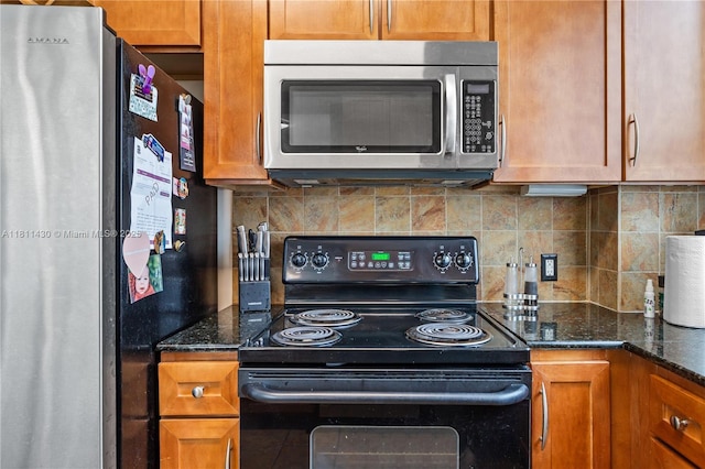 2000 N Bayshore Dr Unit 401, Miami, FL 33137 - kitchen featuring stainless steel microwave, black electric range, freestanding refrigerator, and decorative backsplash