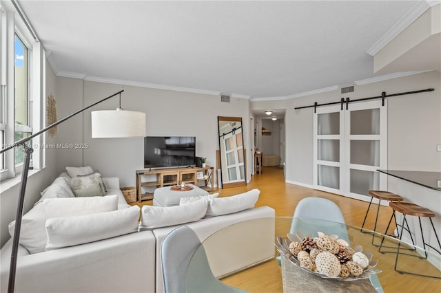 2000 N Bayshore Dr Unit 401, Miami, FL 33137 - living area with wood finished floors, a barn door, healthy amount of natural light, and ornamental molding