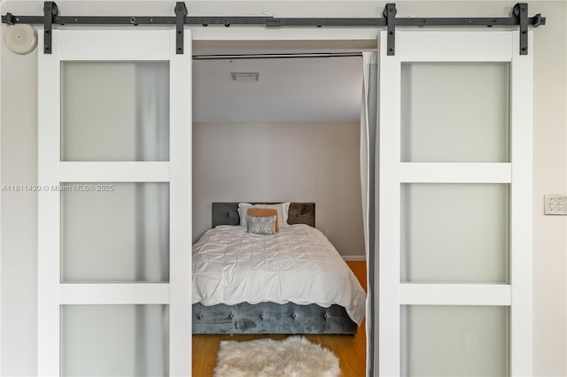 2000 N Bayshore Dr Unit 401, Miami, FL 33137 - bedroom featuring a barn door and wood finished floors