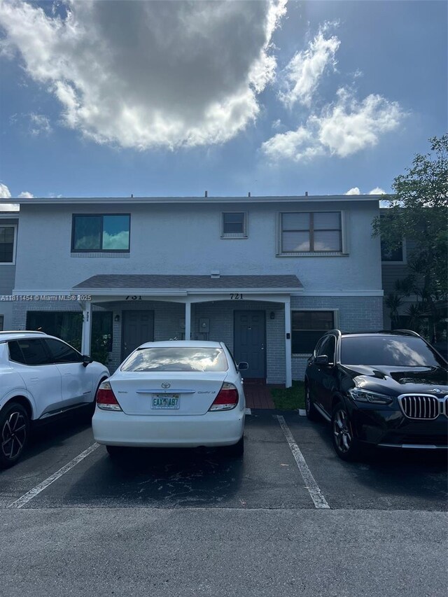 721 NW 105th Ter Unit 721, Pembroke Pines, FL 33026 - view of front facade with uncovered parking, brick siding, and stucco siding