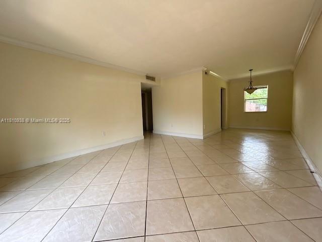 8475 SW 94th St Unit 116E, Miami, FL 33156 - unfurnished room with crown molding, light tile patterned floors, and baseboards