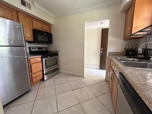 8475 SW 94th St Unit 116E, Miami, FL 33156 - kitchen with appliances with stainless steel finishes, a sink, crown molding, brown cabinetry, and light tile patterned floors
