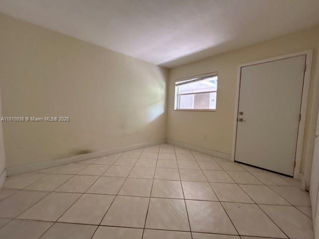 8475 SW 94th St Unit 116E, Miami, FL 33156 - spare room with light tile patterned floors and baseboards