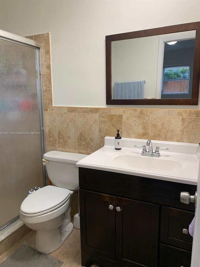 4752 SW 127th Ct, Miami, FL 33175 - bathroom featuring tile walls, vanity, a shower stall, tile patterned floors, and a wainscoted wall