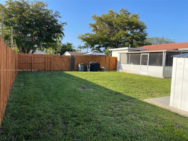 4752 SW 127th Ct, Miami, FL 33175 - fenced backyard featuring a sunroom and a gate