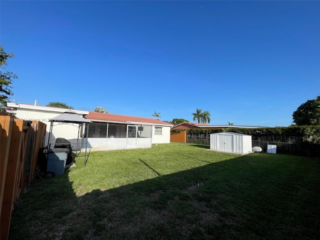 4752 SW 127th Ct, Miami, FL 33175 - fenced backyard featuring a storage unit and a sunroom