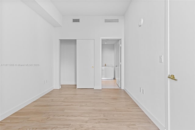 2678 Tigertail Ave Unit 513, Coconut Grove, FL 33133 - unfurnished bedroom with ensuite bath, light wood finished floors, and baseboards