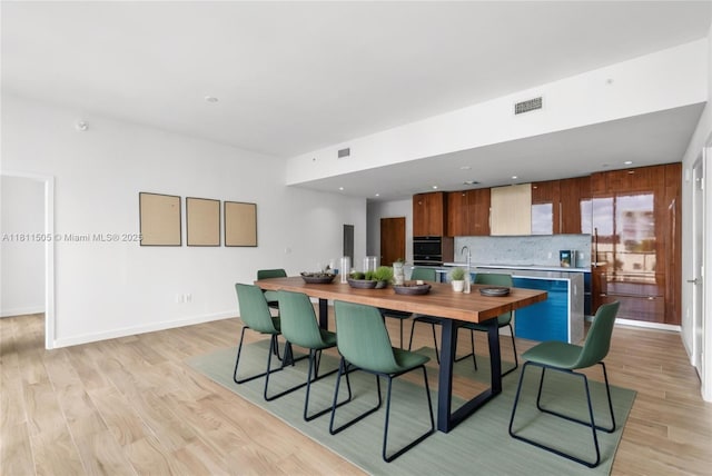 2678 Tigertail Ave Unit 513, Coconut Grove, FL 33133 - dining area with light wood finished floors and baseboards