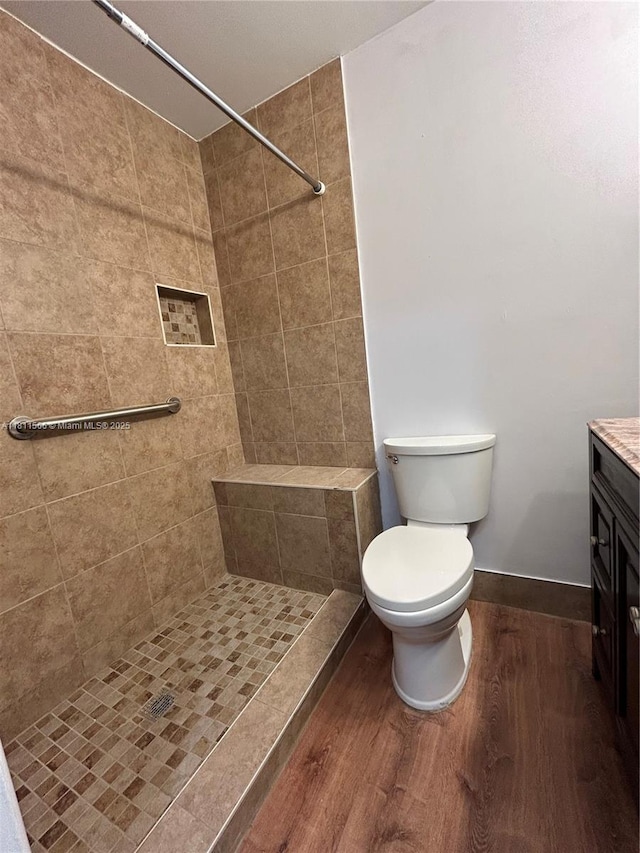322 Briarwood Cir Unit 1-17, Hollywood, FL 33024 - bathroom with wood finished floors, vanity, toilet, a tile shower, and baseboards