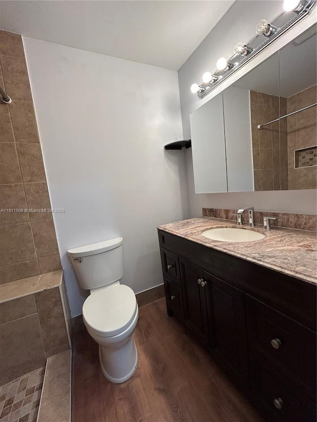 322 Briarwood Cir Unit 1-17, Hollywood, FL 33024 - bathroom with a tile shower, wood finished floors, vanity, and toilet