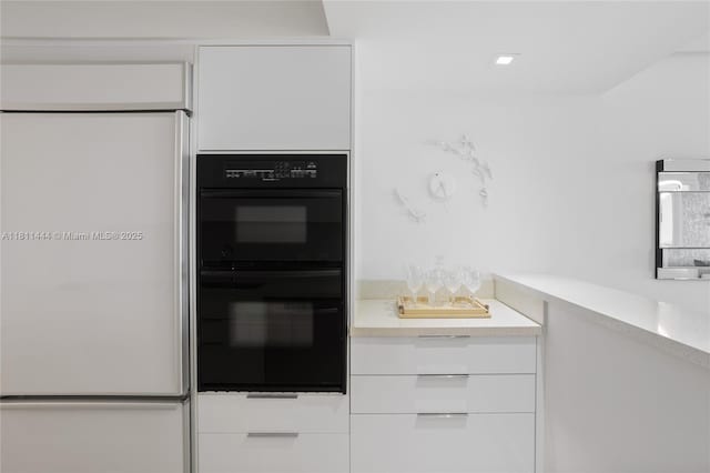 1800 S Ocean Dr Unit 1708, Hallandale Beach, FL 33009 - kitchen with white fridge, white cabinetry, modern cabinets, and light countertops