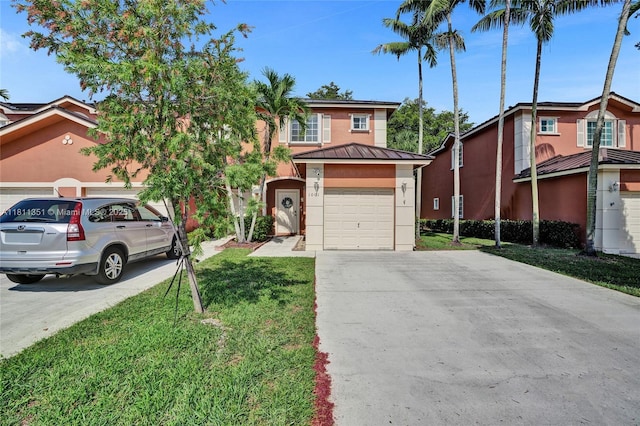 1001 NW 100th Ave, Pembroke Pines, FL 33024 - view of front of home with driveway, stucco siding, metal roof, a standing seam roof, and a front lawn